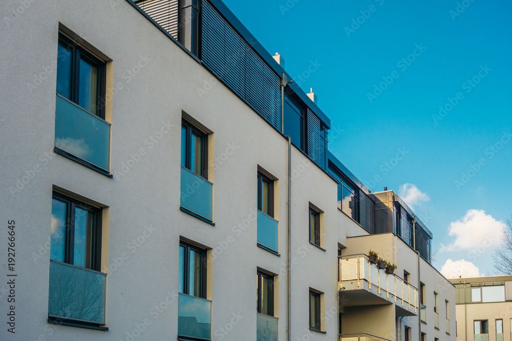 white apartment buildings with blue colored balcony