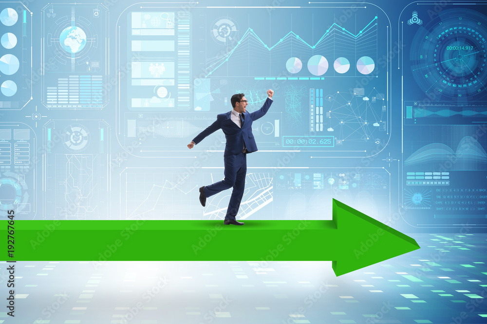 Businessman walking on arrow in business concept Businessman walking on arrow in business concept