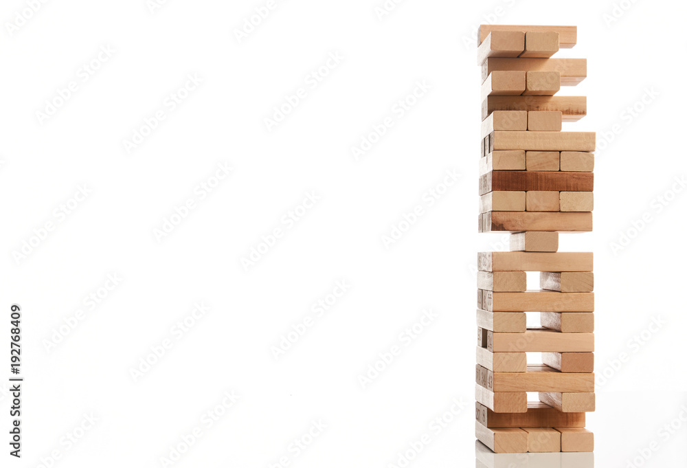 Wooden blocks tower isolated on white background with copy space, close-up. Strategy game as a business plan for team work. Planning, risk and strategy of project management in business Wooden blocks tower isolated on white background with copy space, close-up. Strategy game as a business plan for team work. Planning, risk and strategy of project management in business