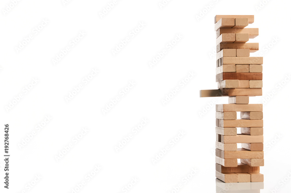 Wooden blocks tower isolated on white background with copy space, close-up. Strategy game as a business plan for team work. Planning, risk and strategy of project management in business Wooden blocks tower isolated on white background with copy space, close-up. Strategy game as a business plan for team work. Planning, risk and strategy of project management in business