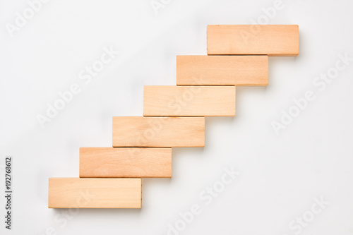 Wooden blocks in shape of a staircase as step for success in business. 