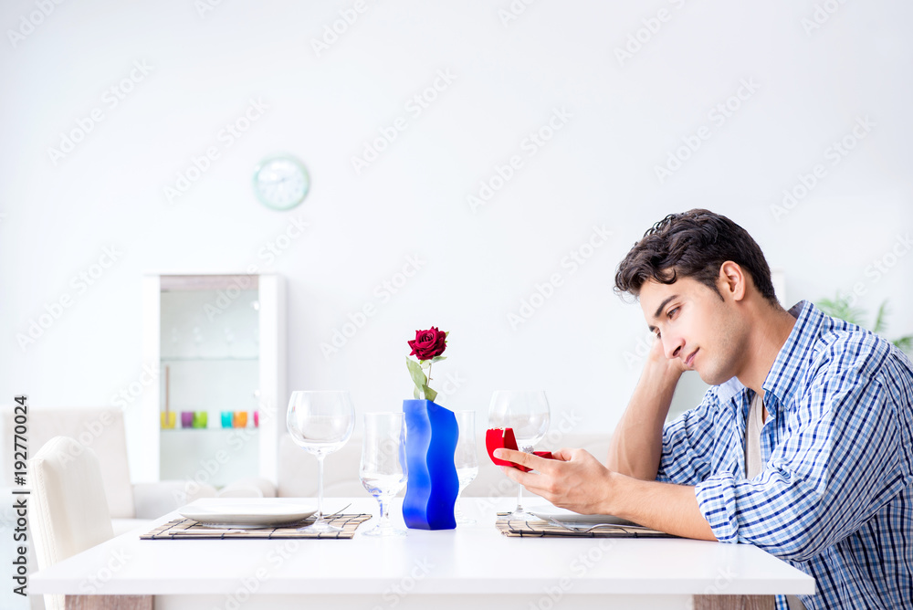 Man alone preparing for romantic date with his sweetheart Man alone preparing for romantic date with his sweetheart