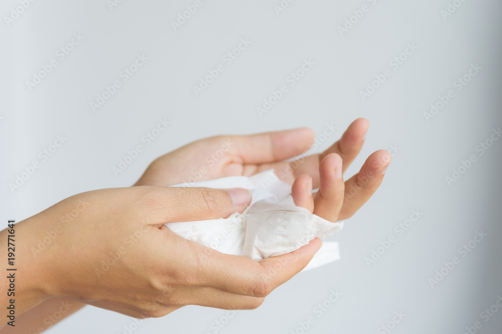 Woman cleaning her hands by using white tissue paper. isolated on a white background. Woman cleaning her hands by using white tissue paper. isolated on a white background.
