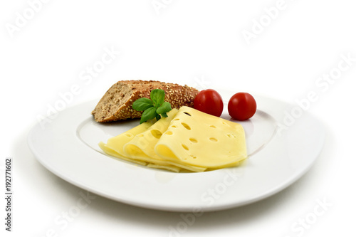 Slice of cheese with garnish stock images. Piece of cheese with tomatoes and basil. Cheese isolated on a white background. Healthy snack images