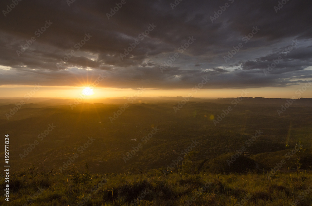 A sunset in clouds by the mountain A sunset in clouds by the mountain