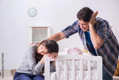 Young dad cannot stand baby crying photo