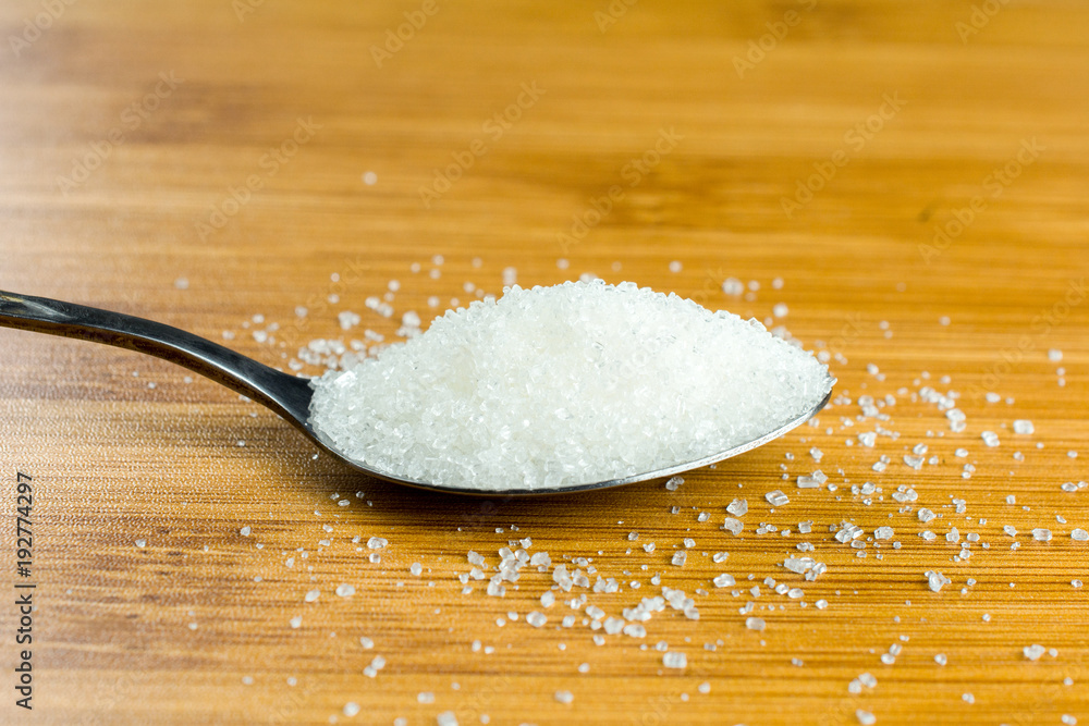 sugar pile spoon wooden table. copy space, close up, selective focus