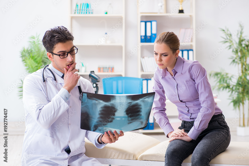 Fototapeta premium Doctor examining x-ray images of patient