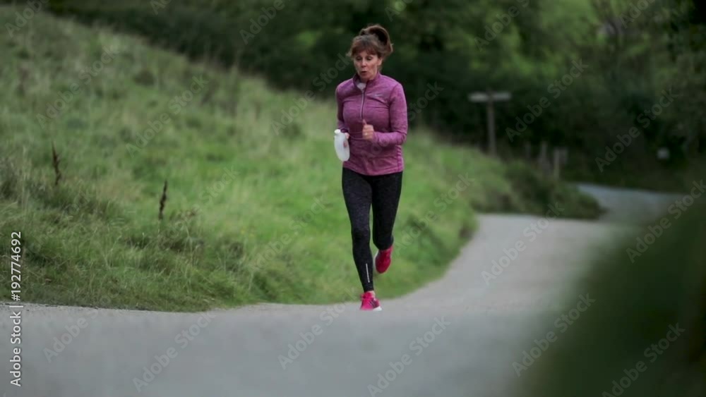 Senior Woman Running in the Lake District Senior Woman Running in the Lake District