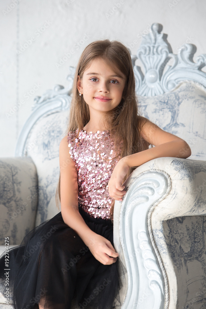 Fototapeta premium Portrait of mother and daughter in a beautiful interior room. Portrait, family values, childhood.