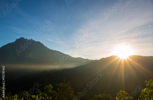 beautiful view of sunrise with mountain and ray of light 