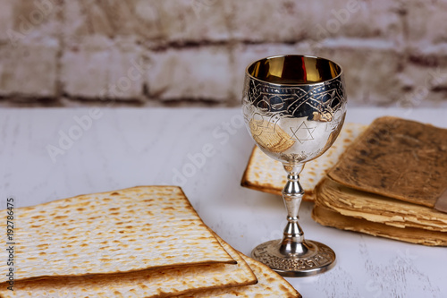 Matzo for Passover with metal tray and wine on table