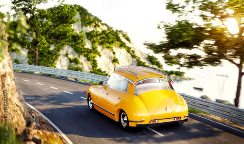 Cute little retro car goes by the road along beautiful harbor between mountai...