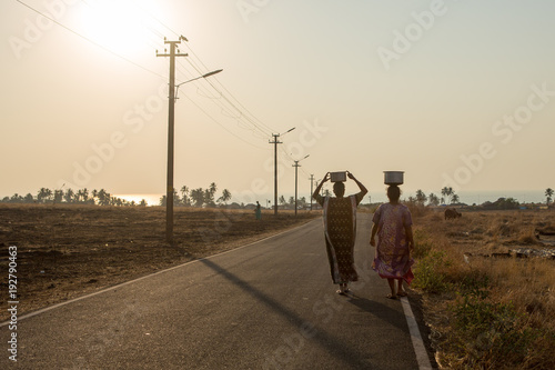Villagers carry water in a remote part of India