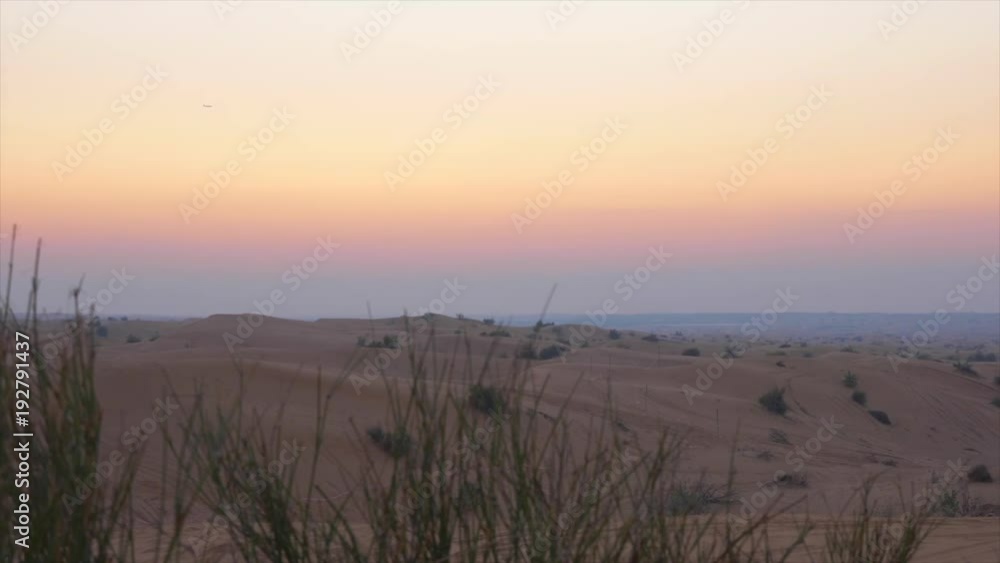 Panoramic landscape evening sky over boundless sand dunes in wild desert Panoramic landscape evening sky over boundless sand dunes in wild desert