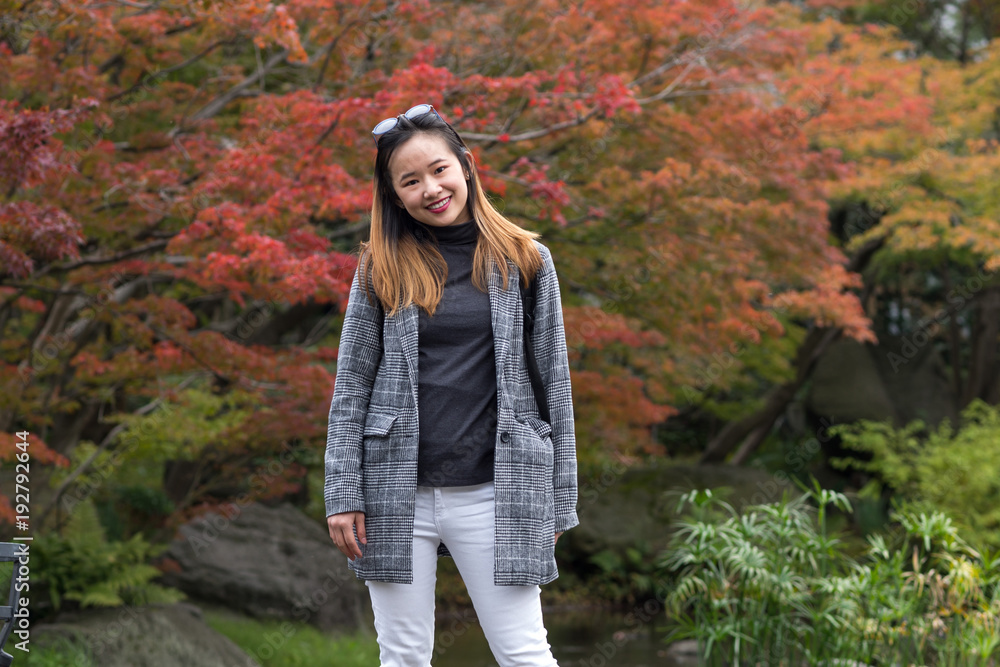 a beautiful asian model posing in a japanese garden and displaying an on trend fashion style a beautiful asian model posing in a japanese garden and displaying an on trend fashion style