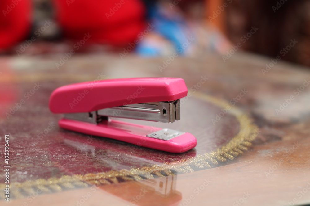 pink stapler on the table, isolated pink stapler on the table, isolated