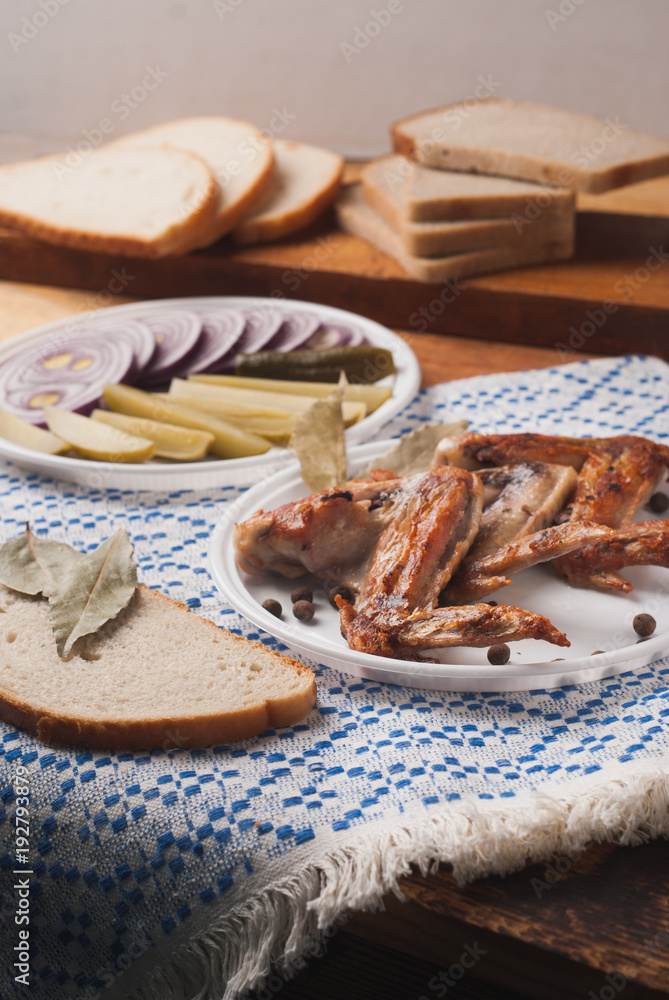 Fried chicken wings in white plastic plate on wooden table, Fried chicken wings in white plastic plate on wooden table,