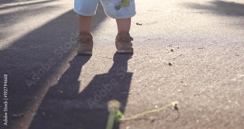 boy child walking relaxation in the park, baby standing on street, close up shoes