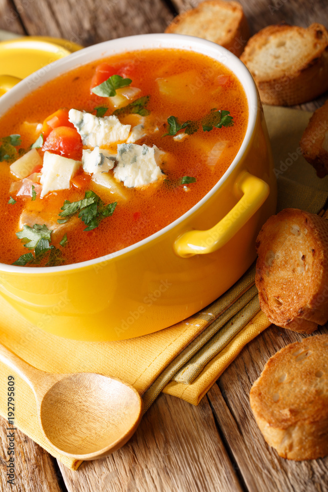 Delicious chicken buffalo soup with tomatoes, celery, carrots and blue cheese close-up in a saucepan. vertical Delicious chicken buffalo soup with tomatoes, celery, carrots and blue cheese close-up in a saucepan. vertical