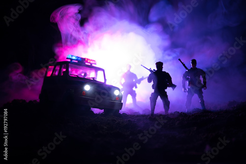 Anti-riot police give signal to be ready. Government power concept. Police in action. Smoke on a dark background with lights. Blue red flashing sirens. Dictatorship power