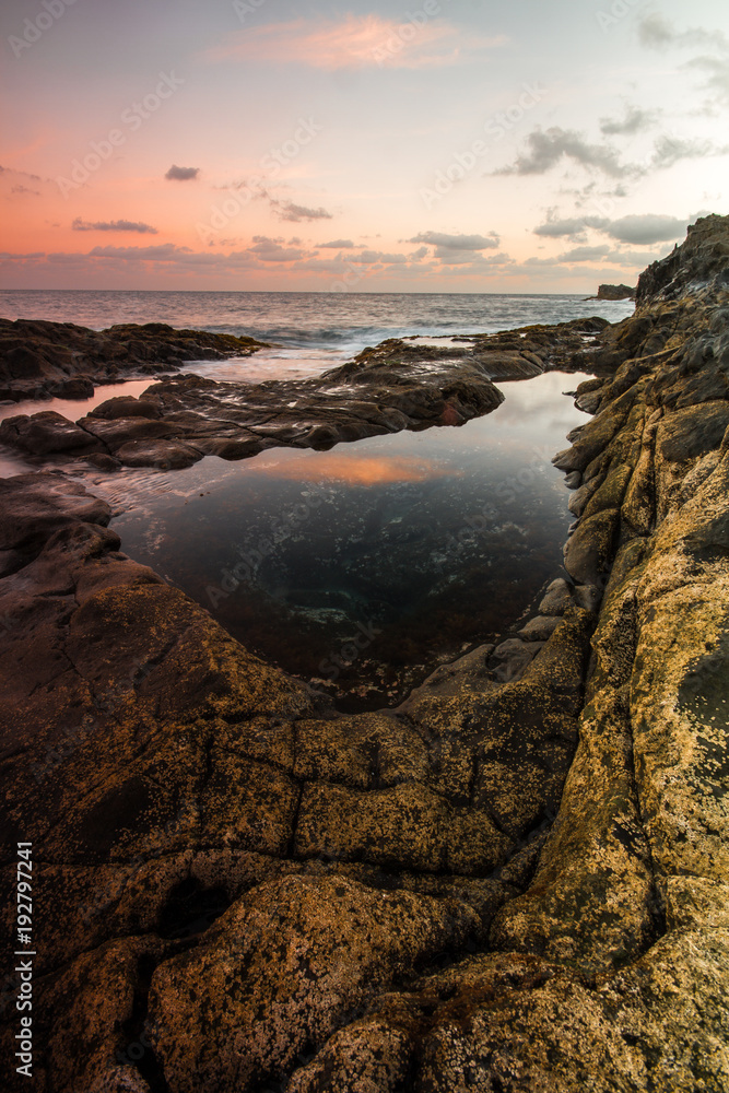 Long Exposure sunrise, colorful sky, volcanic rock beautiful seascape at Gran Canaria Island Coast in Spain.
