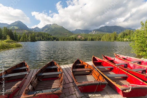 Panorama mountain lake Strbske Pleso in the Tatra mountains. Summers colors and boat for swimming.