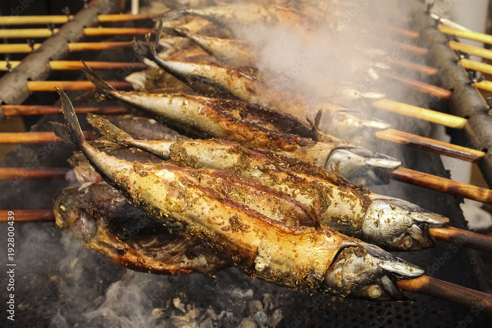 Barbecue with fish. Grilled fish (mackerel) on a stick Barbecue with fish. Grilled fish (mackerel) on a stick