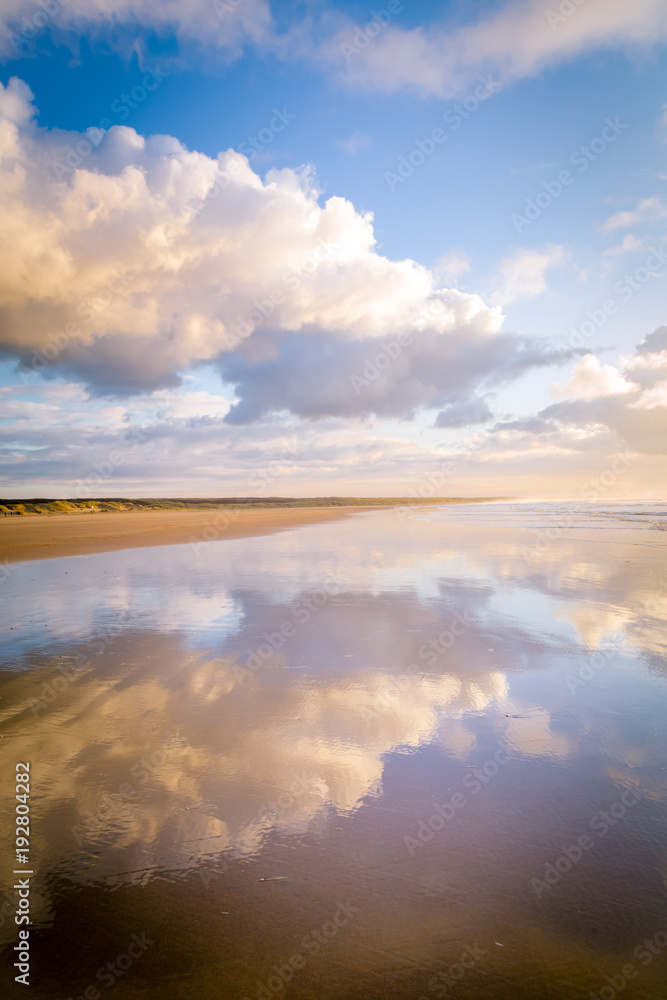 Walking along the beach during sunset in IJmuiden the Netherlands,