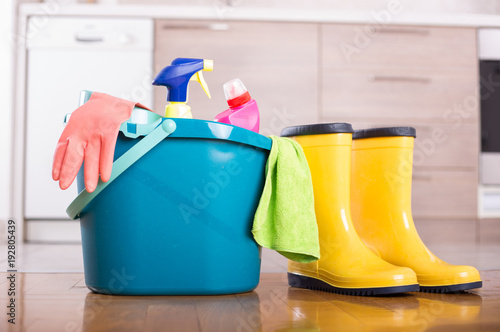 Cleaning equipment on floor in kitchen