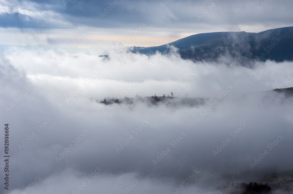 Be in the clouds. Island among the clouds. Mountain landscape among the clouds.