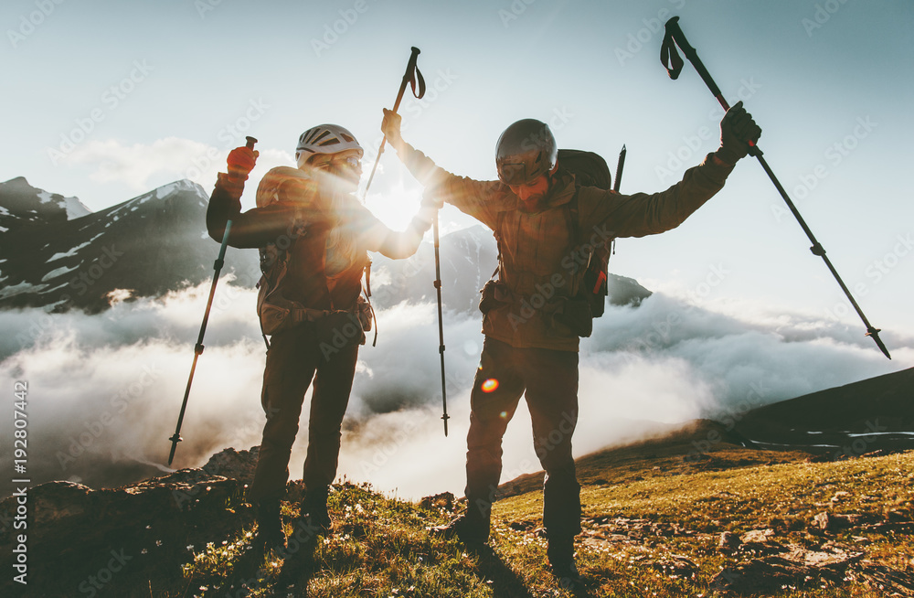 Happy travel couple man and woman on mountain summit love and adventure hiking Lifestyle wanderlust concept sunset light. - obrazy, fototapety, plakaty 