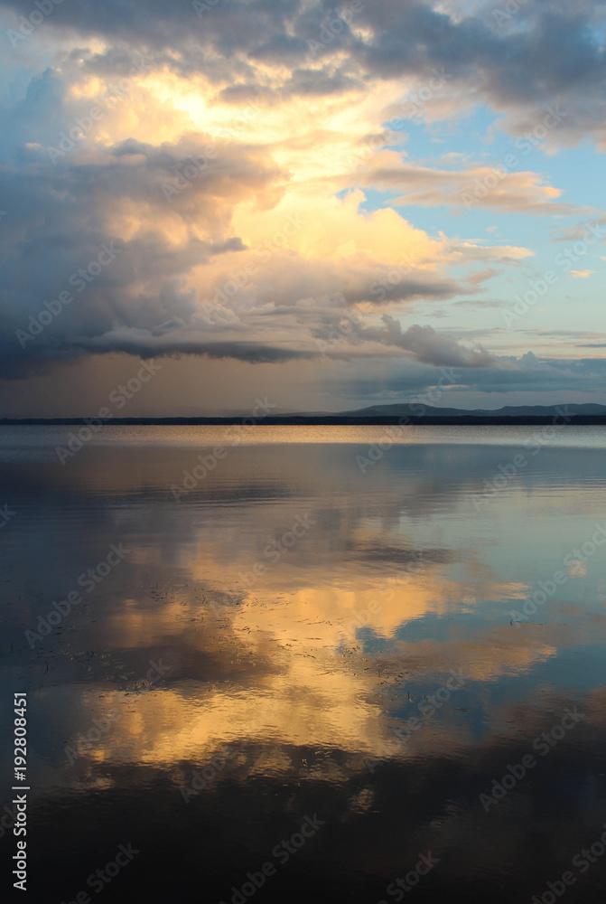Sunset and clouds reflected in Orsa lake.
