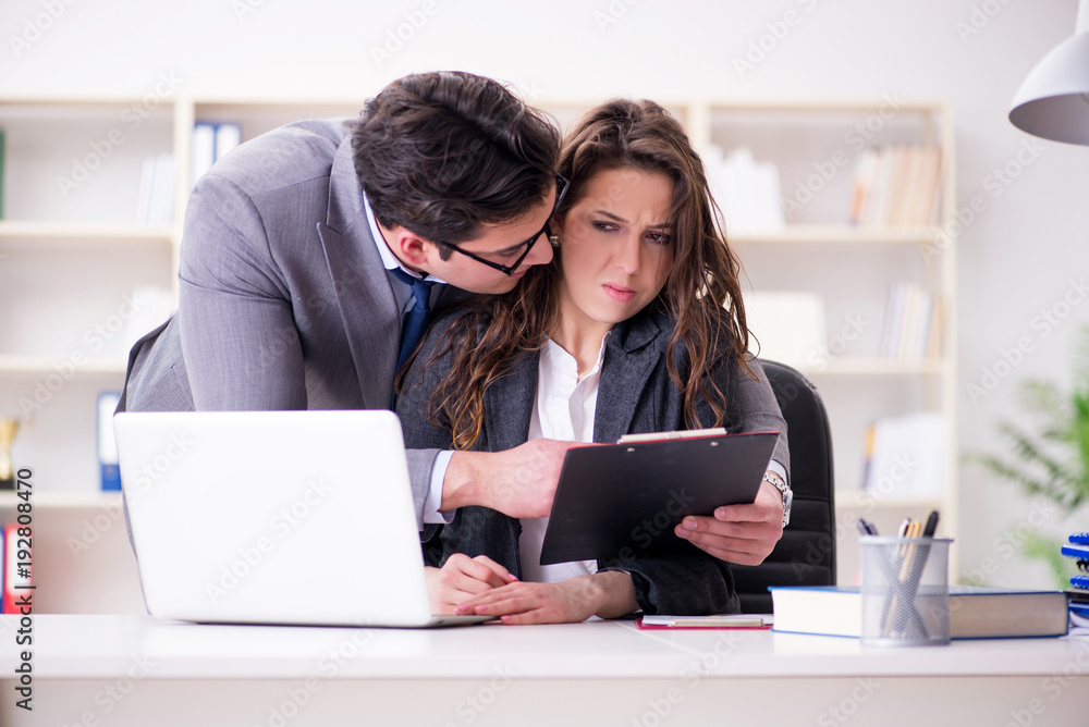 Sexual harassment concept with man and woman in office Sexual harassment concept with man and woman in office