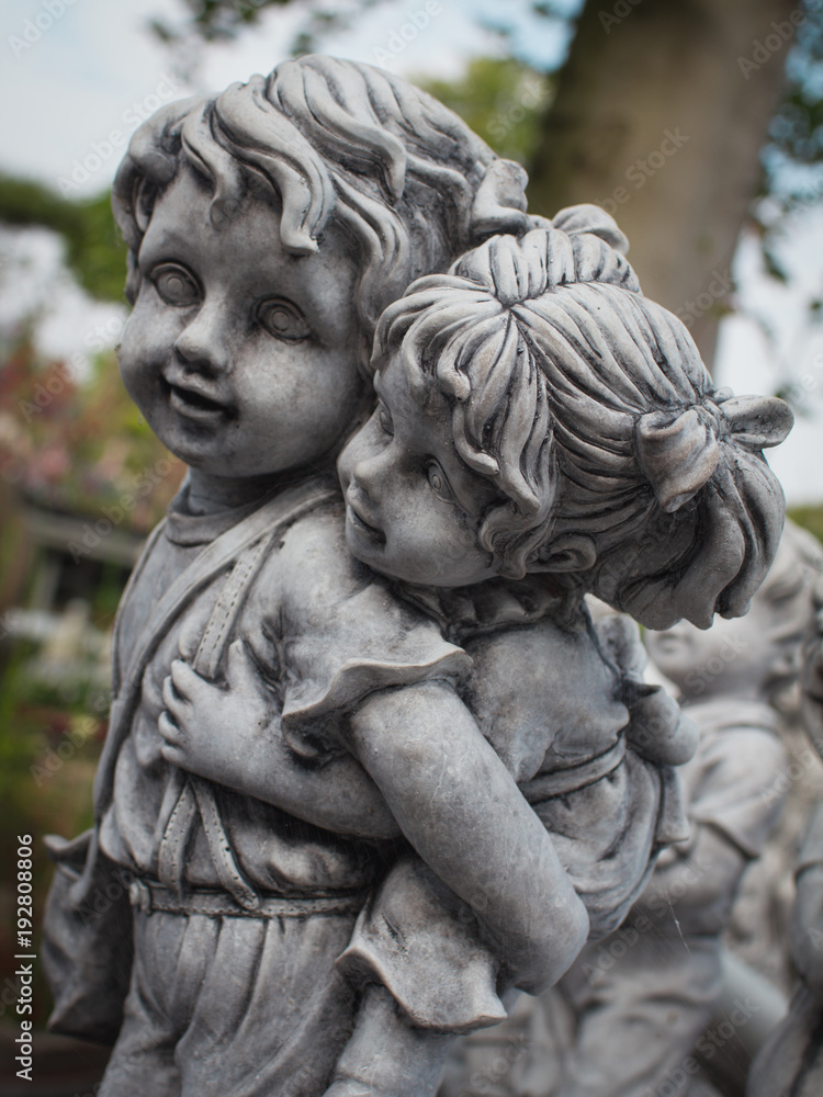 Image of two kids in the park, stone, close-up