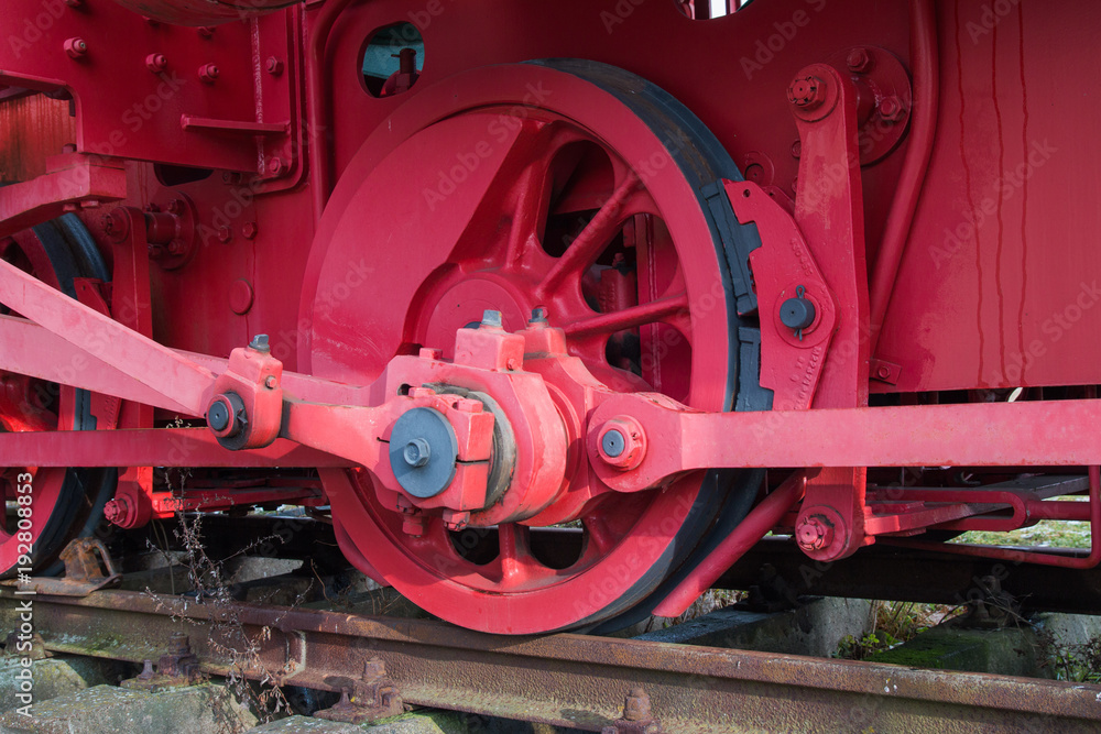 red drive wheel of a steam locomotive