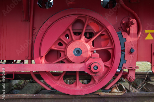 red drive wheel of a steam locomotive