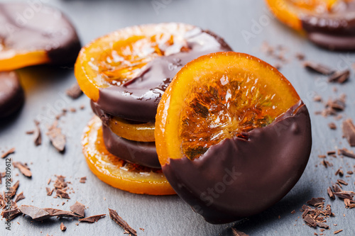 Candied orange slices in chocolate. Slate background