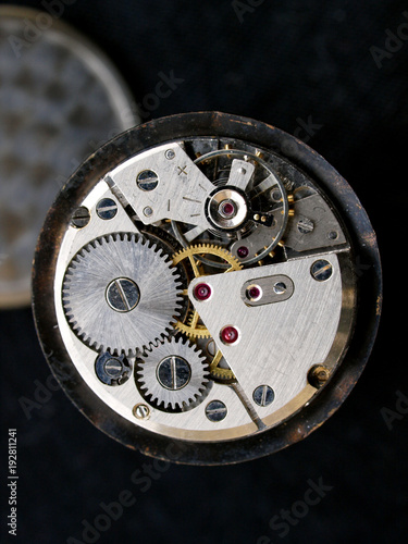 close up of vintage mechanic watch caliber over black background
