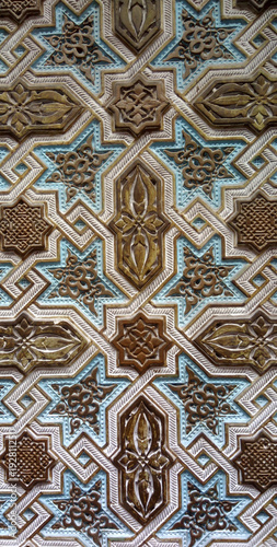 close up detail of colorful geometric patterns of an Islamic mosaic facade