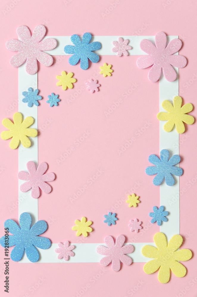 Pink background with colorful flowers and frame for text.