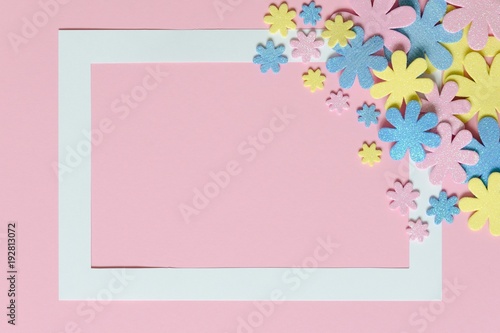 Pink background with colorful flowers and frame for text.