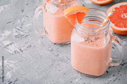 healthy detox smoothie in mason jar of red grapefruit with banana and chia seeds