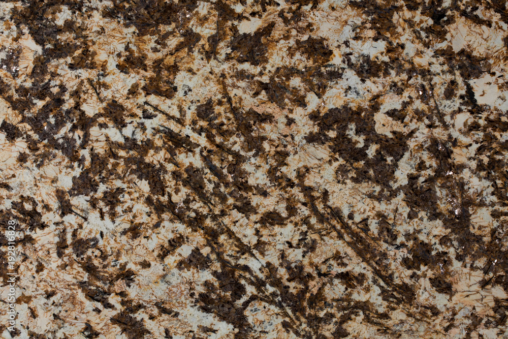 Stone background of mottled brown granite igneous rock. Stone background of mottled brown granite igneous rock.