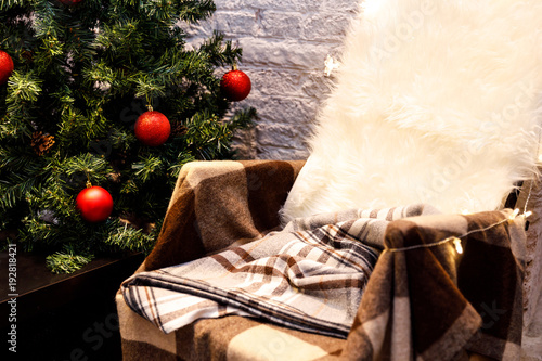 Canvas Print Cozy home, armchair and bedcover with decorated christmas tree