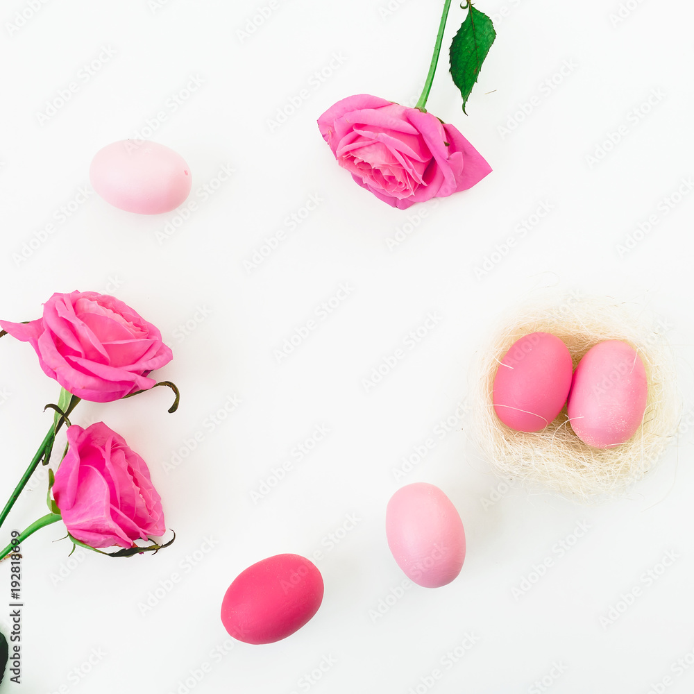 Easter egg and quail eggs in nest and pink roses on white background. Top view, Fat lay. Easter holidays Easter egg and quail eggs in nest and pink roses on white background. Top view, Fat lay. Easter holidays