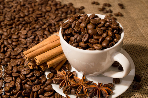 Coffee beans and coffee cup with cinnamon and anise