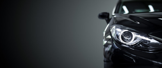 Black modern car on black background.