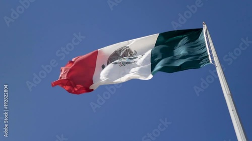 Vertical view of Mexican flag waving in the wind. photo