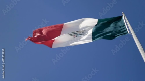 Large vertical view of Mexican flag waving in the wind. photo